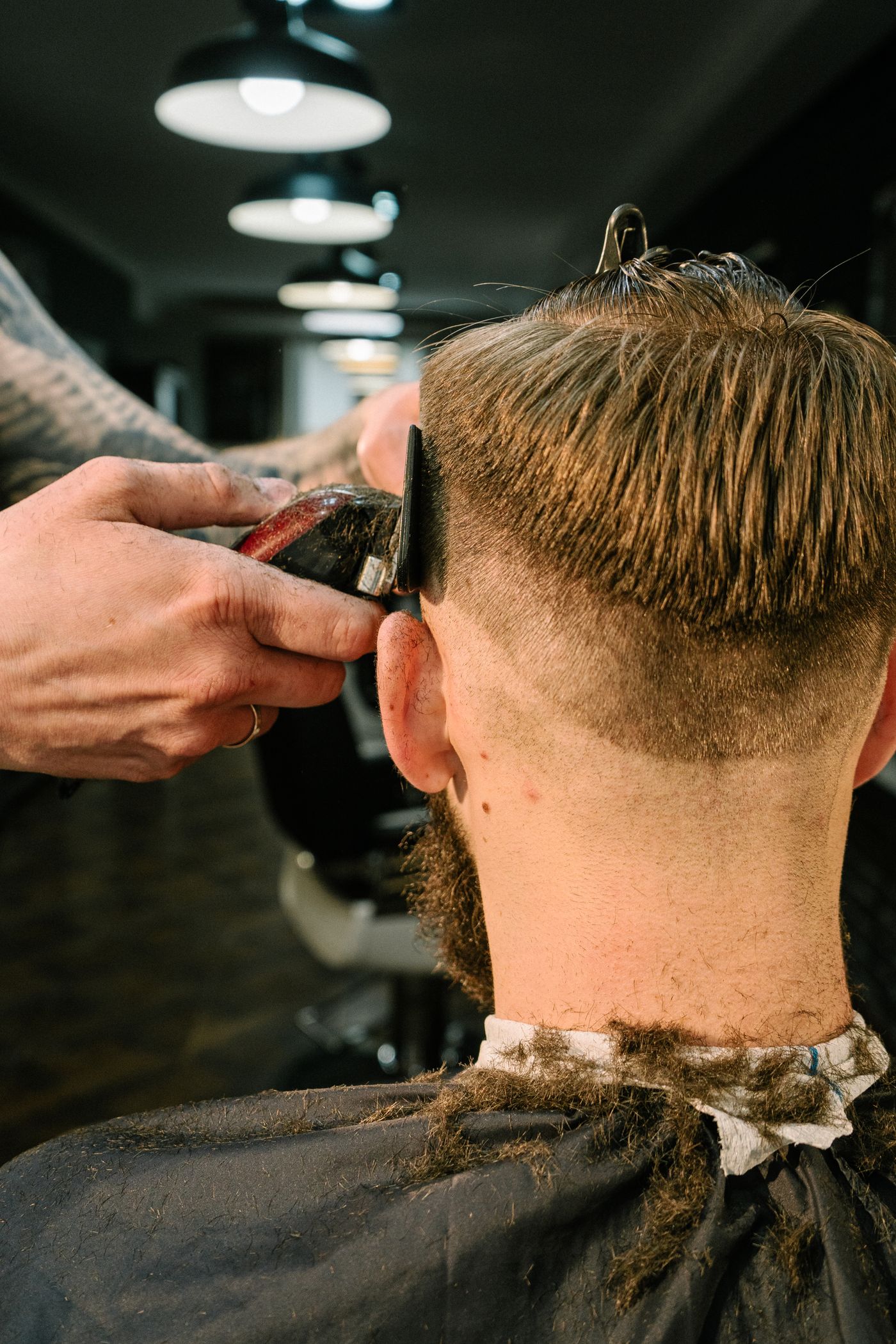 Barber trimming a customer’s hair