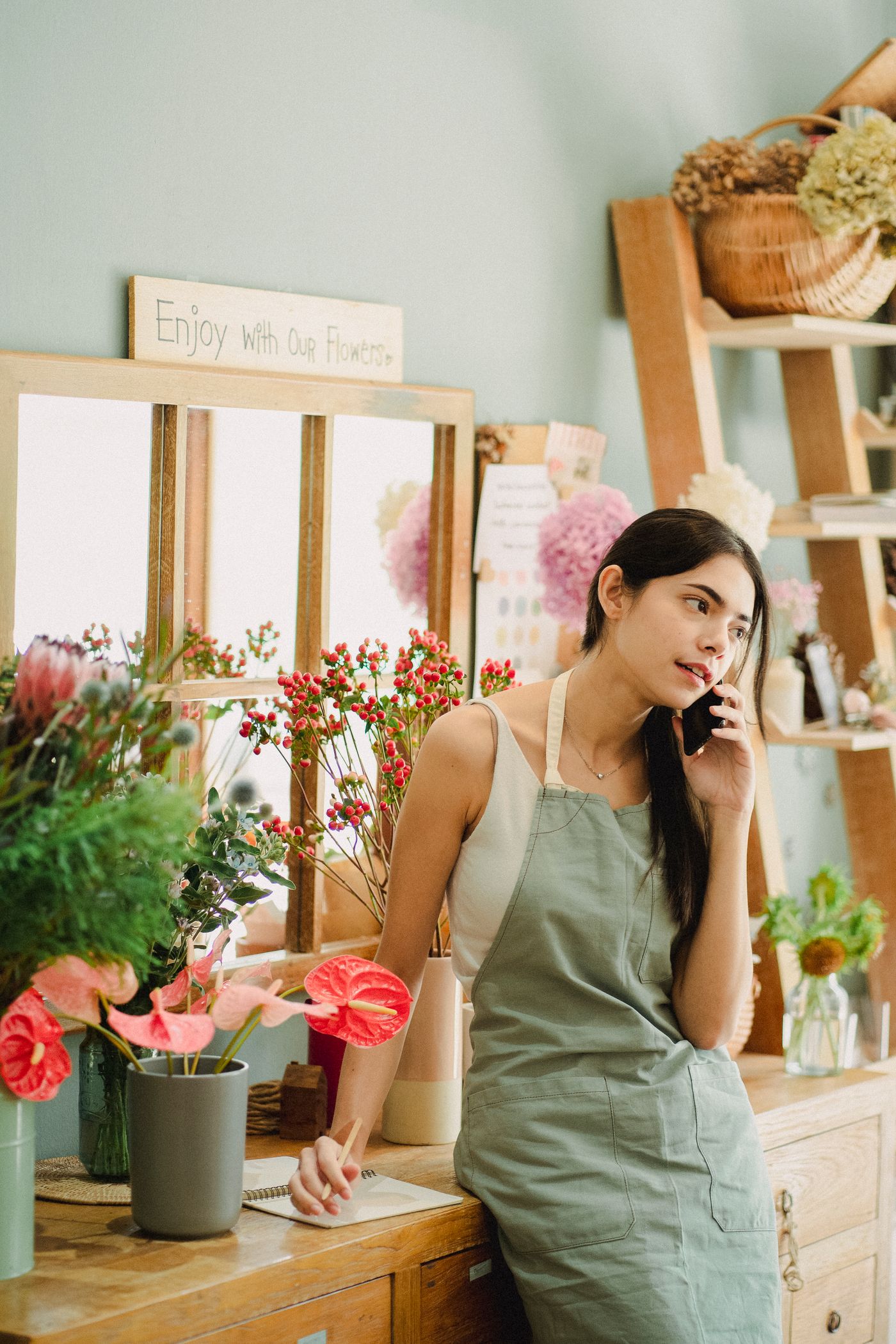 Florist on the phone at her counter