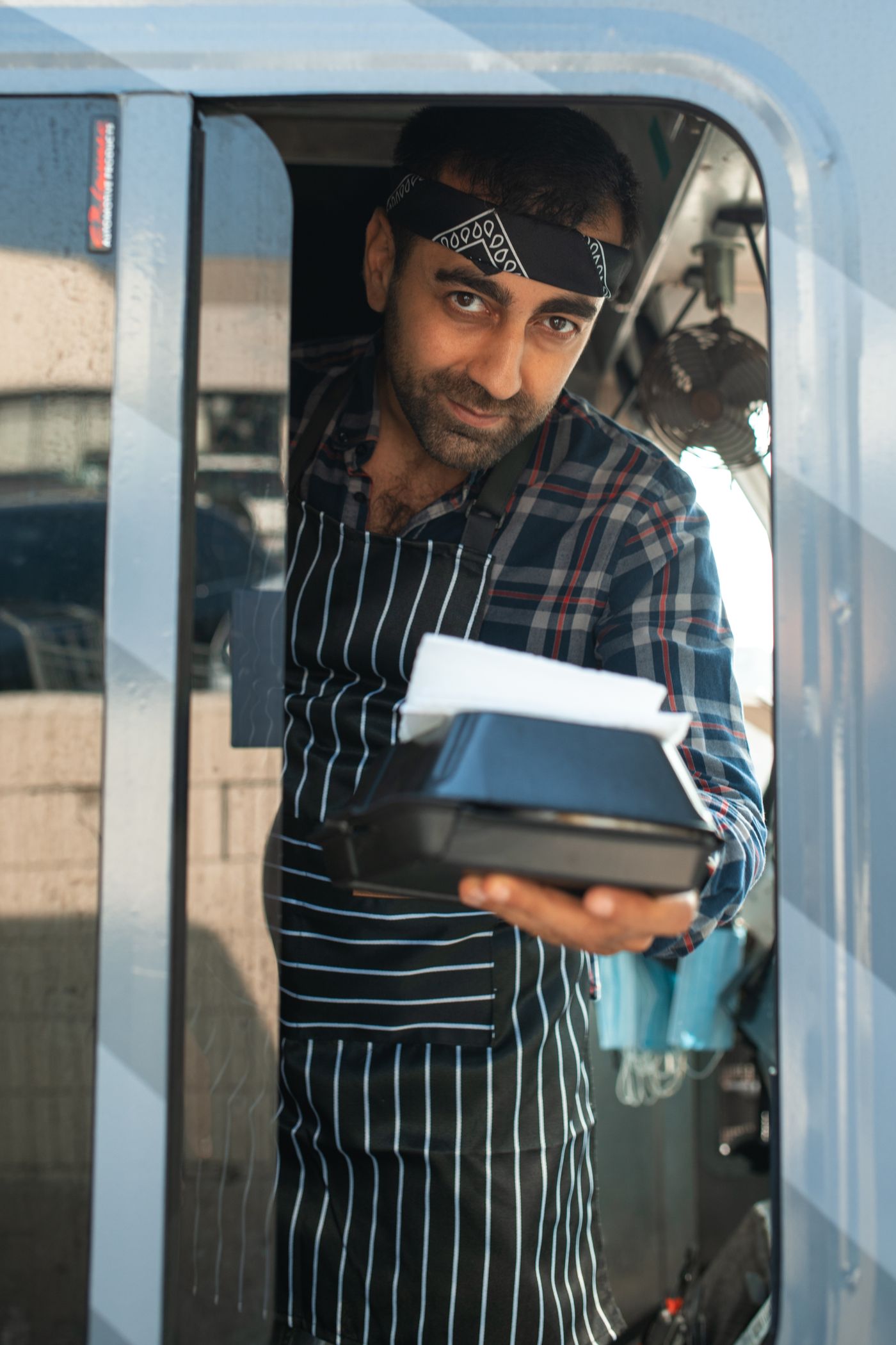 Food truck owner handing out an order