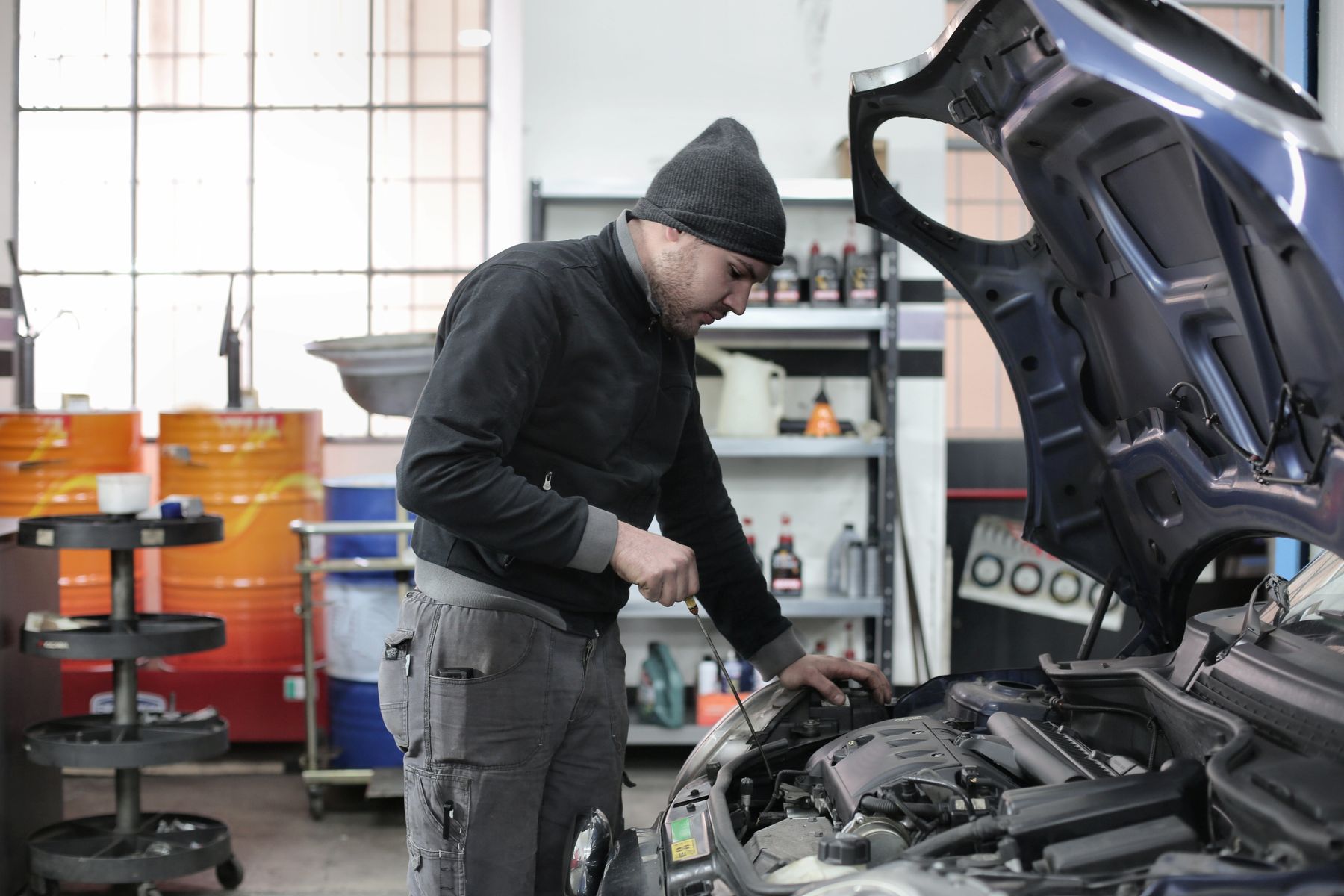 Mechanic inspecting a car on a lift