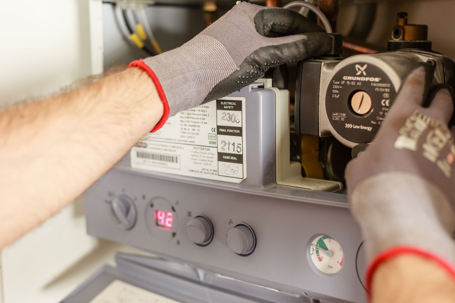Hands adjusting a boiler control